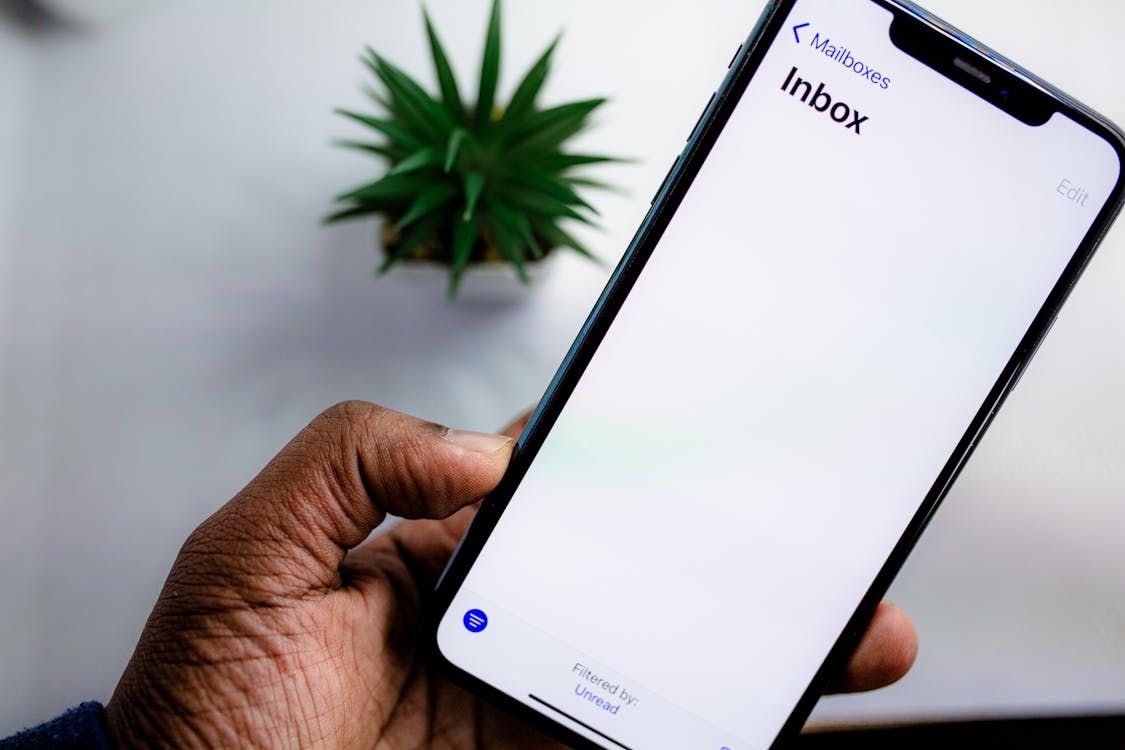Person holding a smartphone checking email notifications