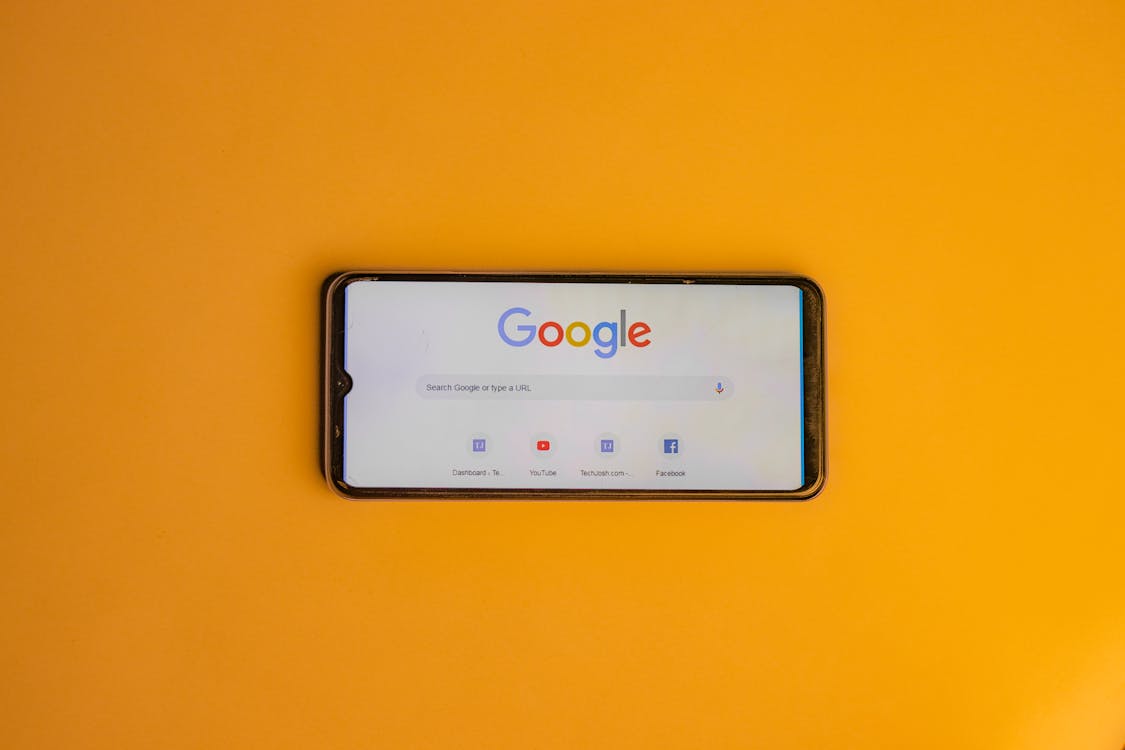 Smartphone displaying a Google search page for digital advertising comparison