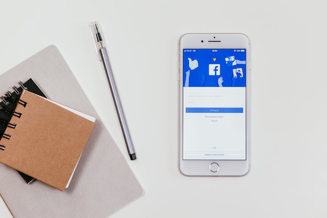 Minimalist workspace with a smartphone showing social media login and a notepad