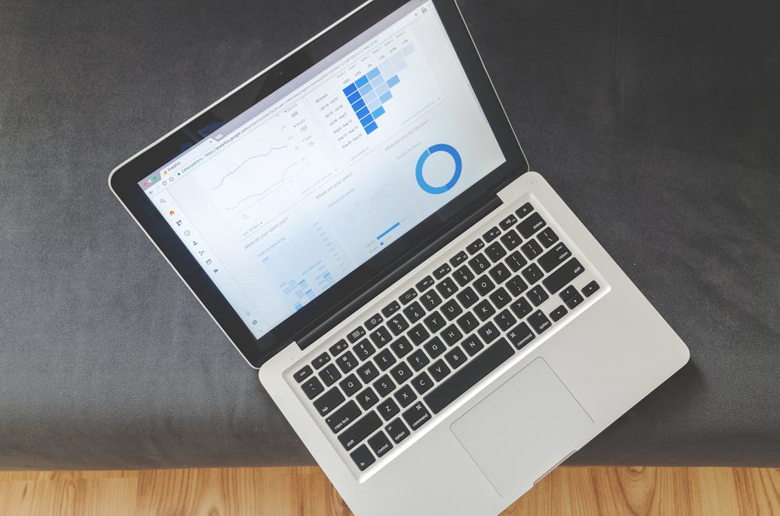 Overhead view of a laptop showing data visualizations and marketing charts