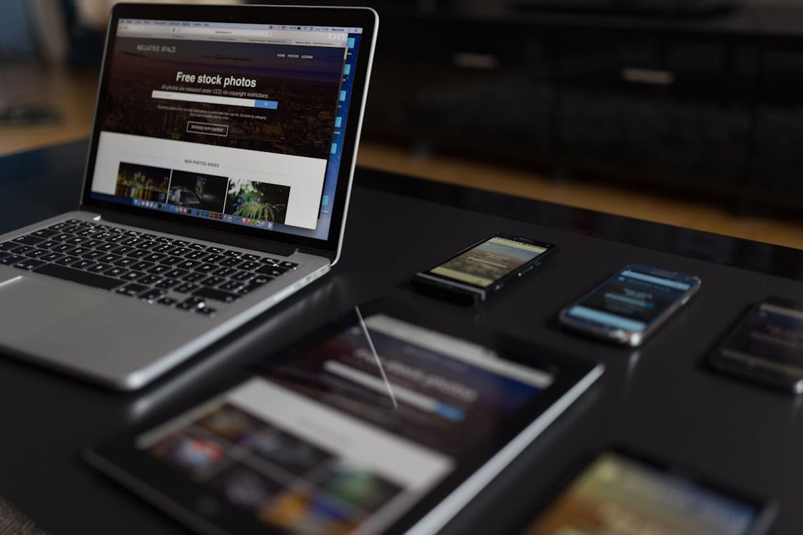 Contemporary workspace with a laptop, tablet, and smartphones for responsive design
